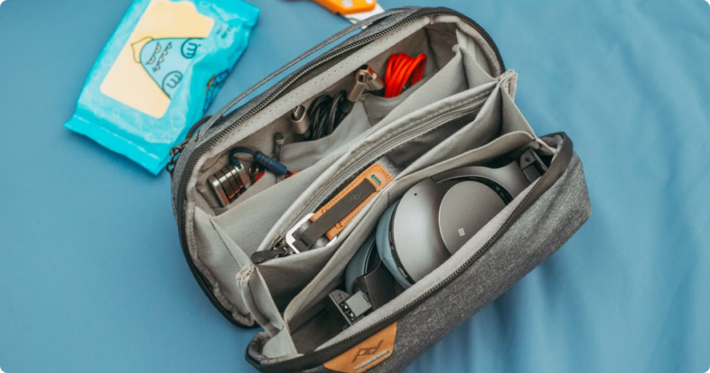Best Travel Accessories: The Ultimate Expert-Tested Guide for Every Trip Type and Budget Flat lay of best travel accessories including packing cubes, passport, headphones, and power bank arranged on a light surface