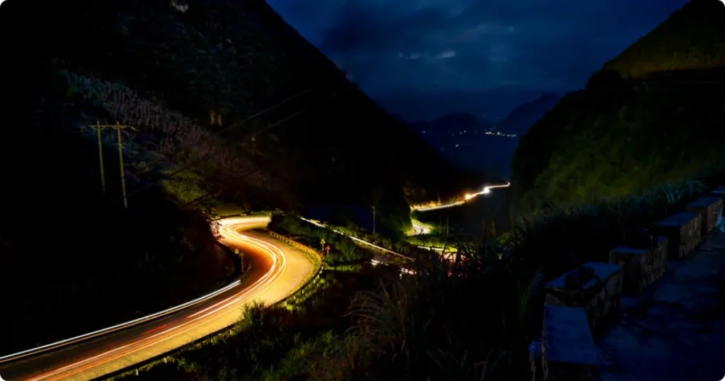 Dark winding mountain road leading up to Haleakala summit before sunrise, Maui Hawaii