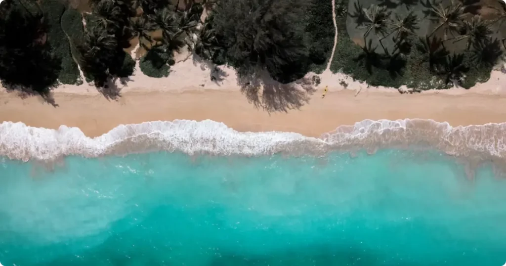 Aerial view of Hawaiian islands surrounded by blue Pacific Ocean, showing multiple islands for island hopping