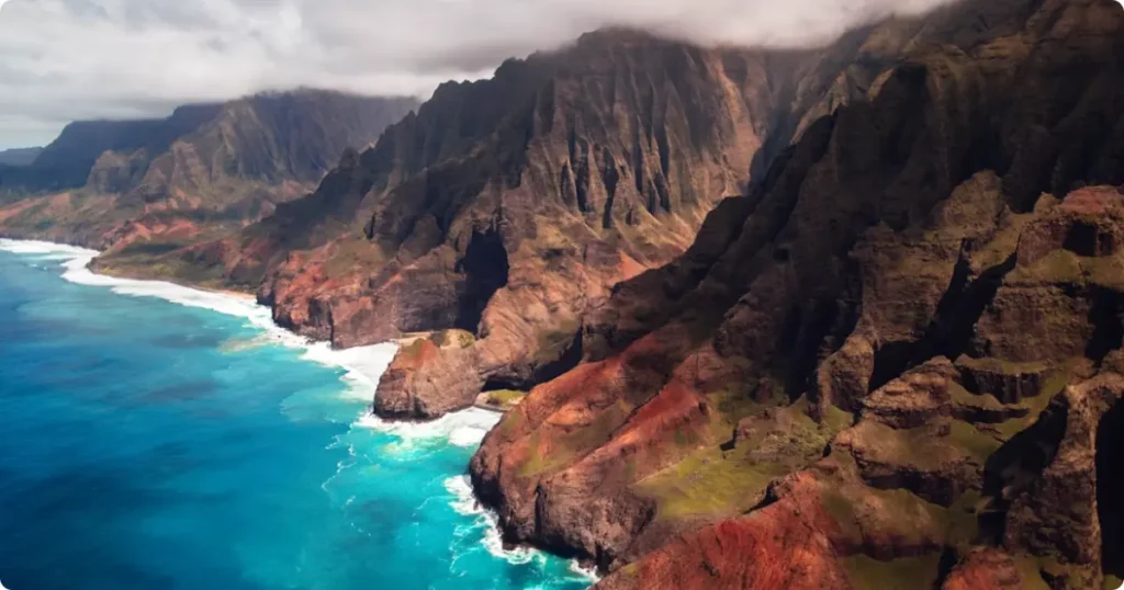 The dramatic green sea cliffs of the Na Pali Coast on Kauai, one of the Hawaiian Islands