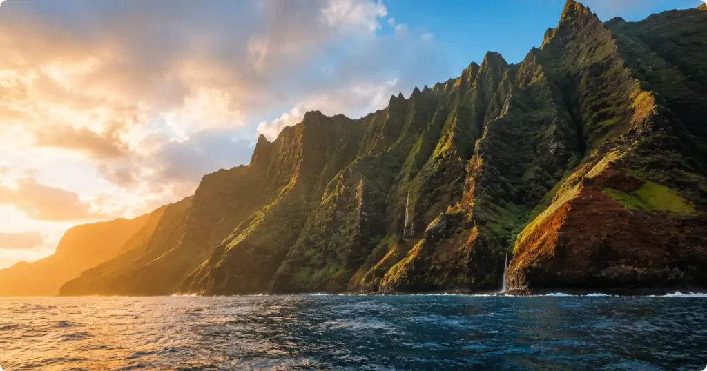 Things To Do In Kauai: The Complete Garden Isle Visitor Guide Na Pali Coast sea cliffs rising above the Pacific Ocean, one of the most iconic things to do in Kauai