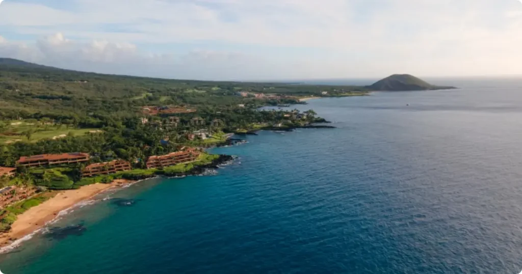 Things To Do In Maui: The Complete Activity and Experience Guide Aerial view of Maui Hawaii coastline with turquoise ocean, lush green cliffs, and volcanic landscape