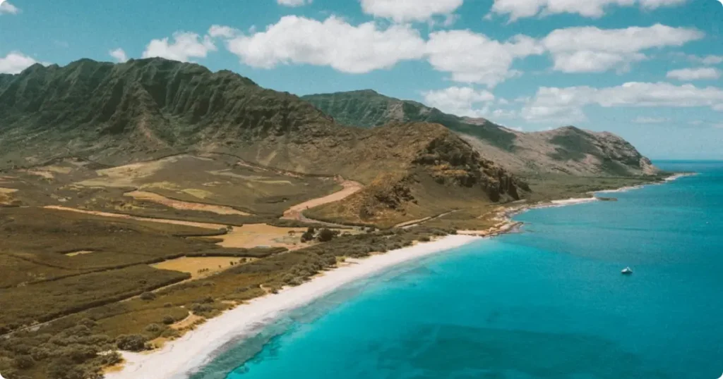Oahu Beyond Waikiki: The Complete Guide to Hawaii’s Most Visited Island Aerial view of Oahu's windward coastline with turquoise water and green mountains, Hawaii